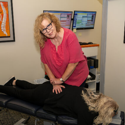 Raynham Chiropractor Dr. Margie adjusting back