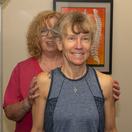 Raynham Chiropractor Dr. Margie correcting posture