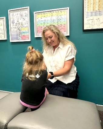 Dr. Carrie interacting with pediatric patient