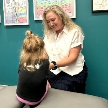 Dr. Carrie in consultation with pediatric patient
