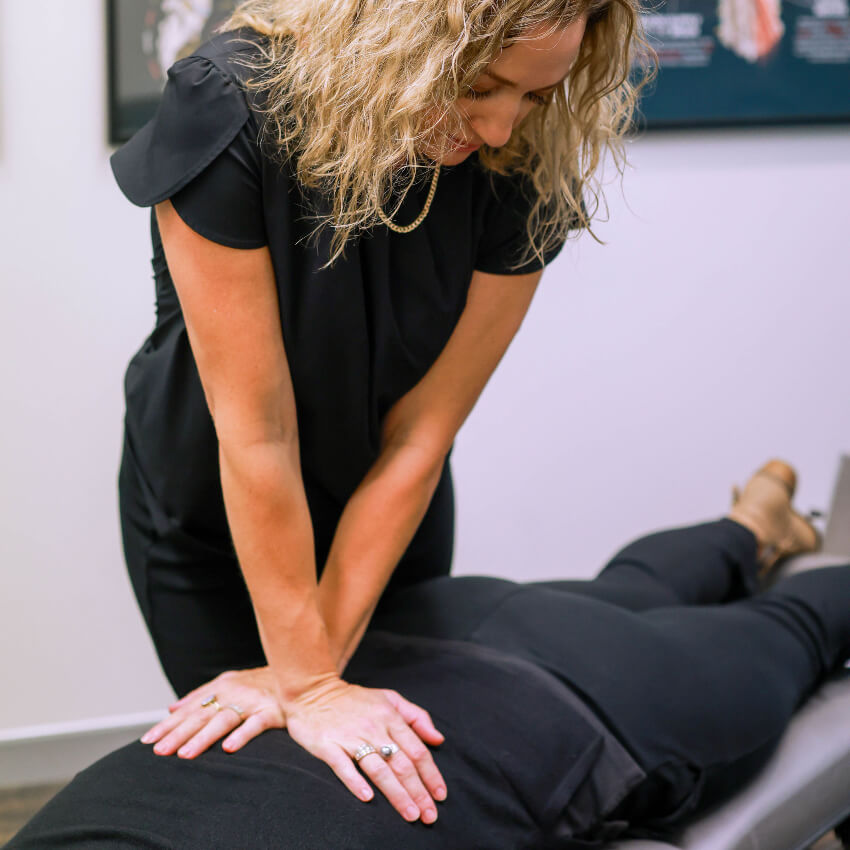 Dr Carrie adjusting patients back