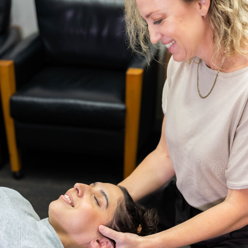 Dr Carrie adjusting patients neck