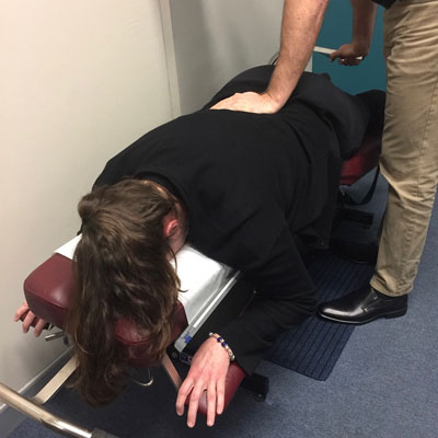 Doctor adjusting a patient on chiropractic table