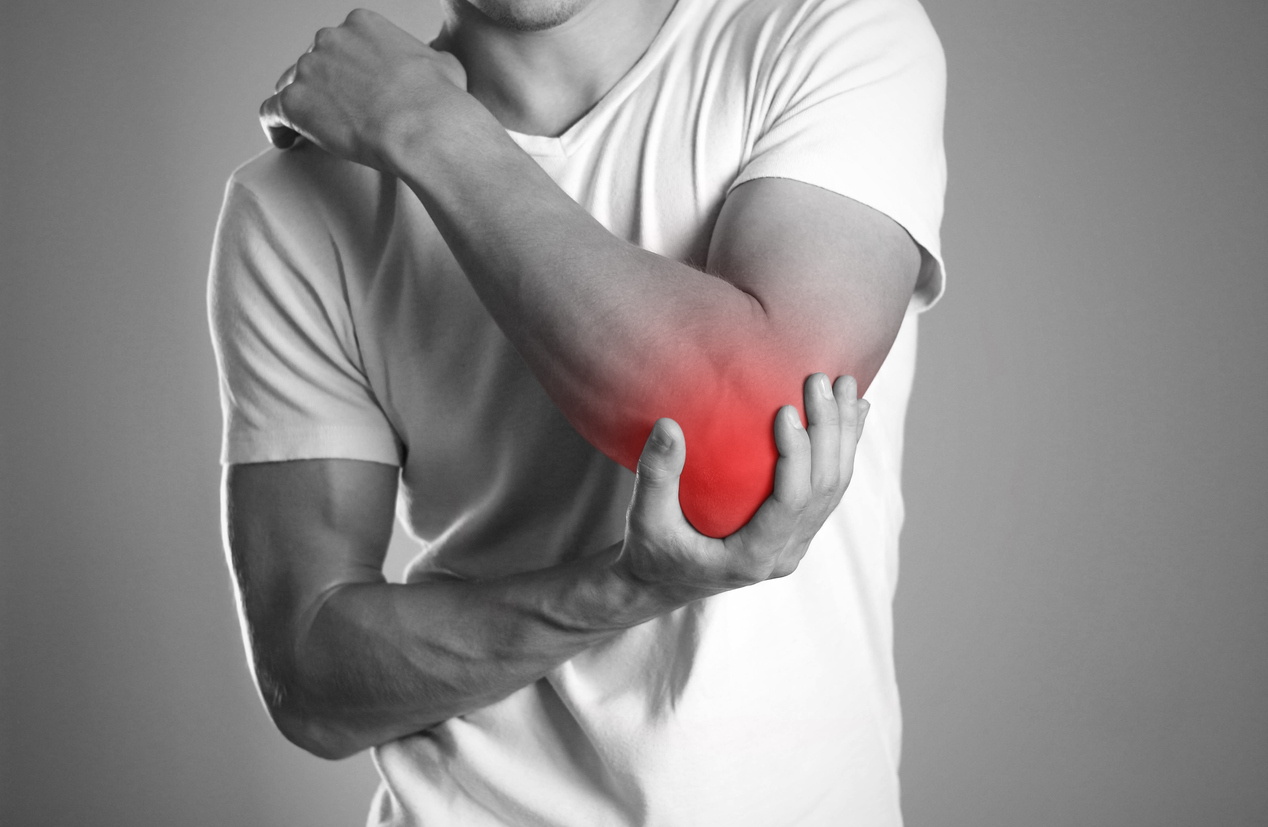 A man holding hands. Pain in the elbow. The hearth is highlighted in red. Close up. Isolated background