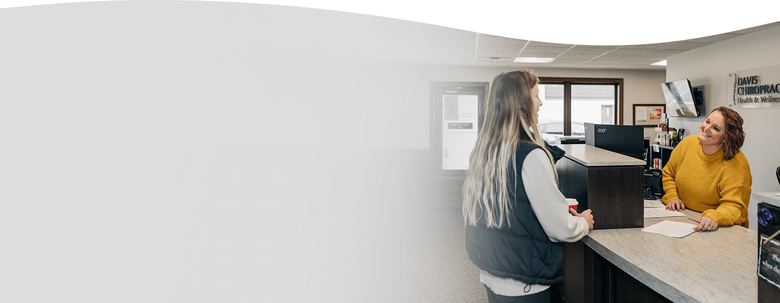 Davis Chiropractic Health & Wellness, P.A. receptionist talking to the client