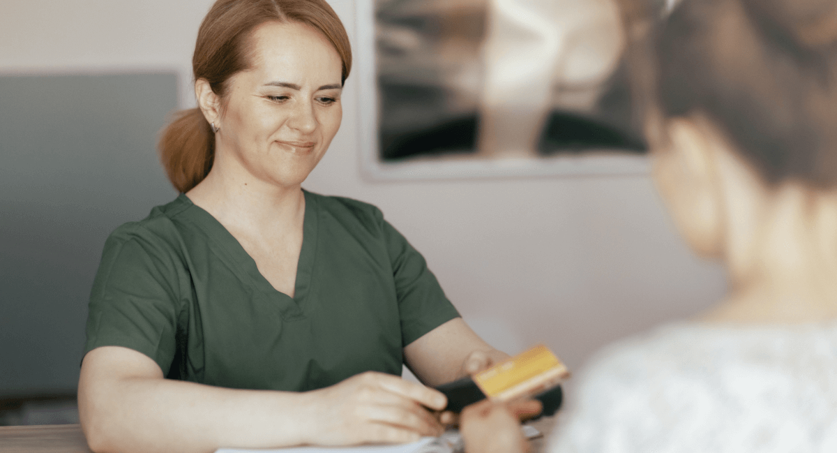 Female patient checking in at reception