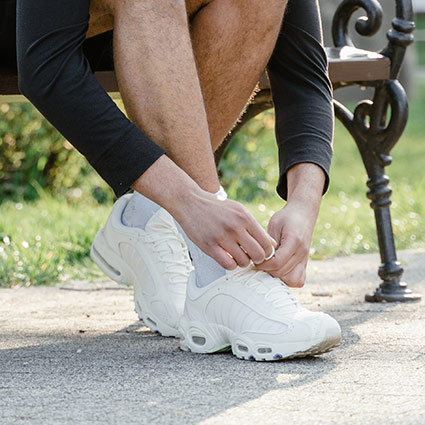 person tying shoes