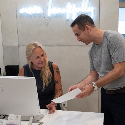 Dr Michael talking with front desk staff
