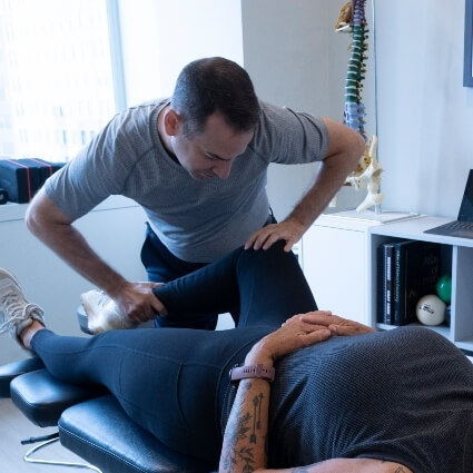 Downtown Toronto chiropractor Dr Michael adjusting patients knee