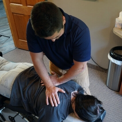 Dr Dalton adjusting patients back