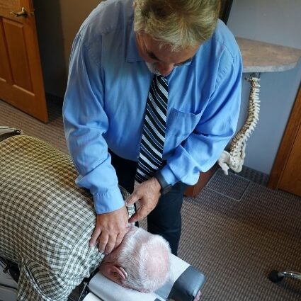 Dr Shawn adjusting patients back