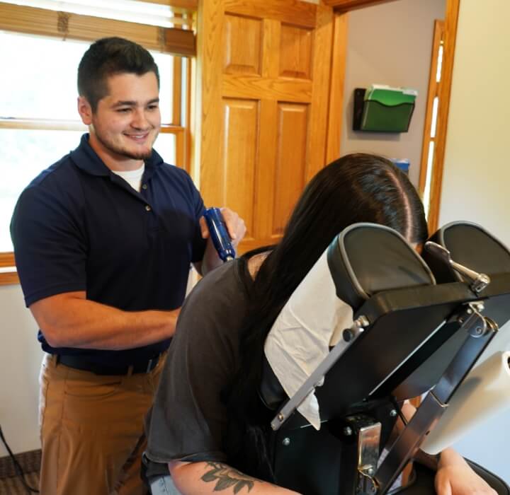 Cadott chiropractor Dr Dalton using tool on patients back