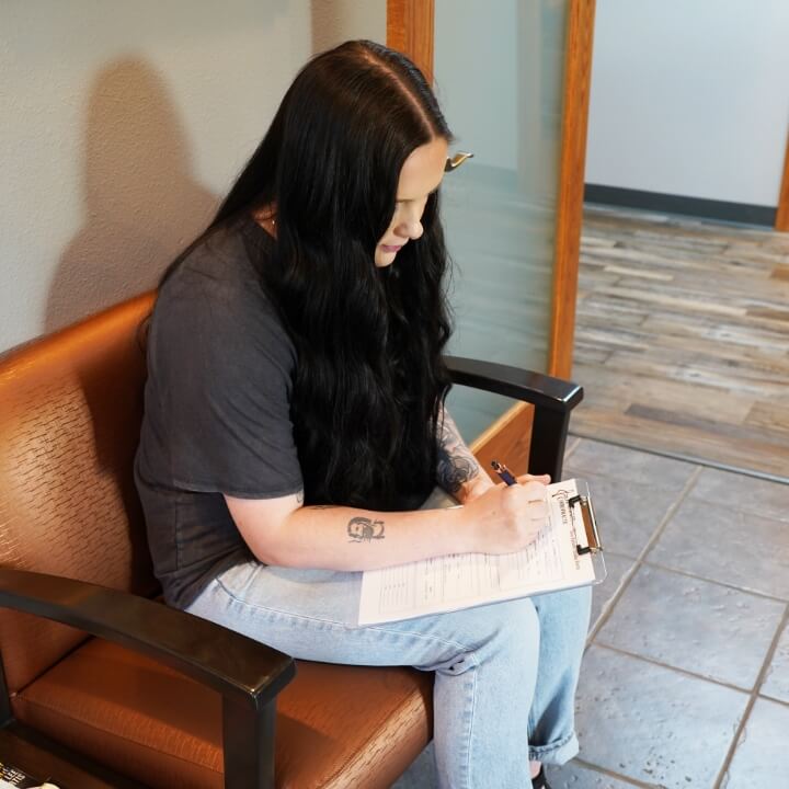 woman filling out paperwork