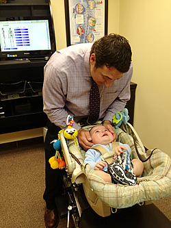 Dr. Verne adjusting infant