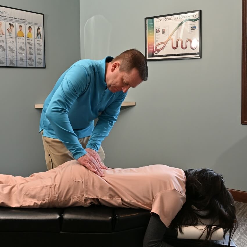 Dr Ryn adjusting patients back