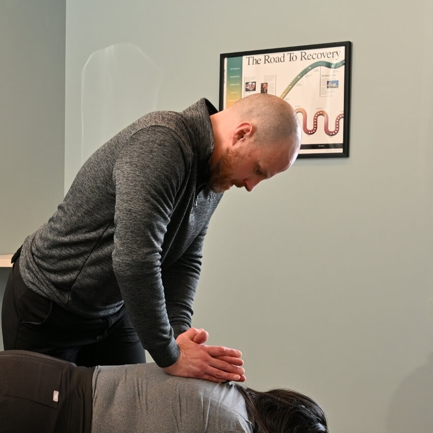 Dr Brett adjusting patients back