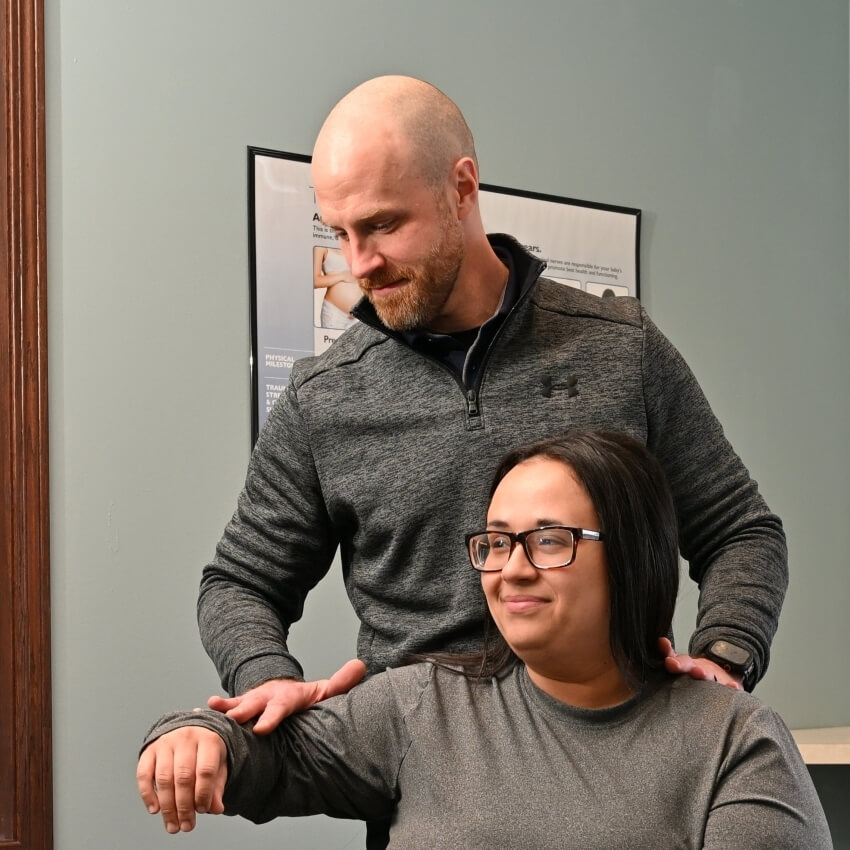 Dr Brett adjusting patients arm