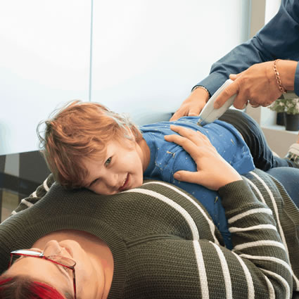 Toddler being adjusted on mom