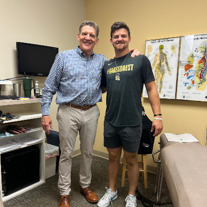 Dr. Rick with patient in exam room