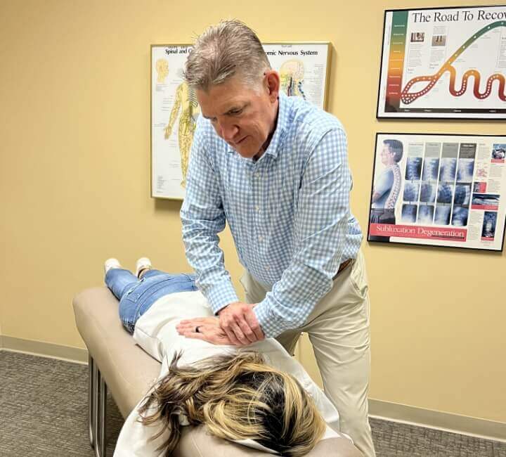 Winston-Salem Chiropractor Dr. Erickson adjusting patient on table