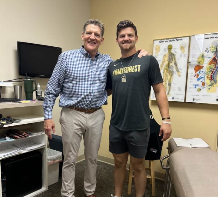 Dr. Erickson and patient posing in exam room