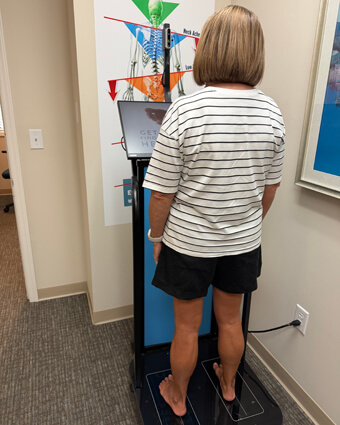 woman standing on orthotic machine