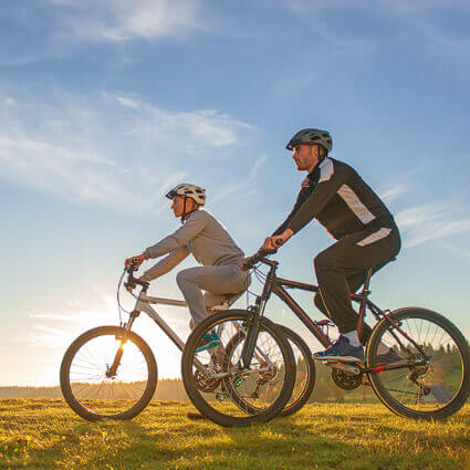 Two men biking together