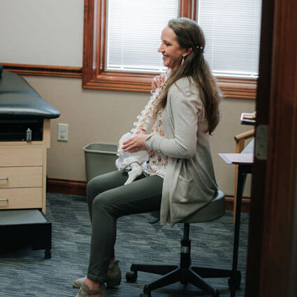 Chiropractor holding spine model