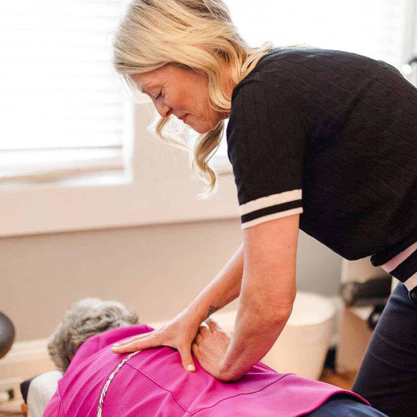 Dr Terri adjusting patients back