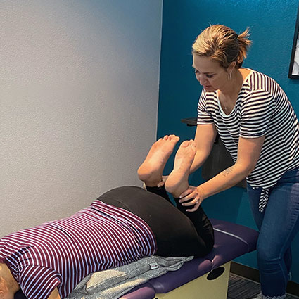 Chiropractor adjusting patients legs