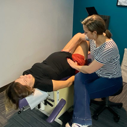 Chiropractor adjusting pregnant patient