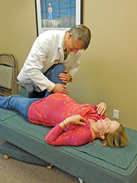Dr. Justin adjusts pregnant patient
