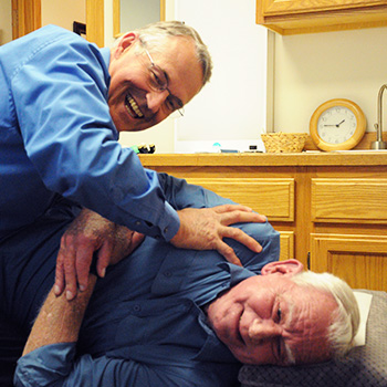 Dr. Michael adjusting patient