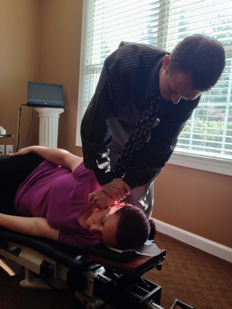 Office member receiving chiropractic adjustment