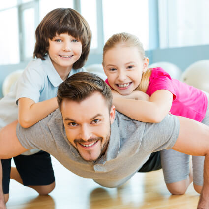 Dad with his two kids on his back