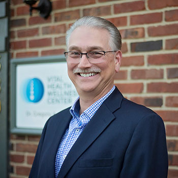 Dr Greg in front of building