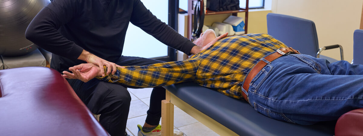 Midlothian chiropractor adjusting a patient's arm