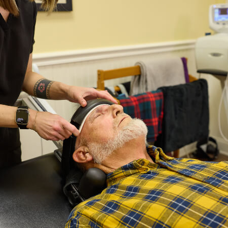 Advanced Care Chiropractic and Wellness Center staff member assisting patient with Chiropractic BioPhysics
