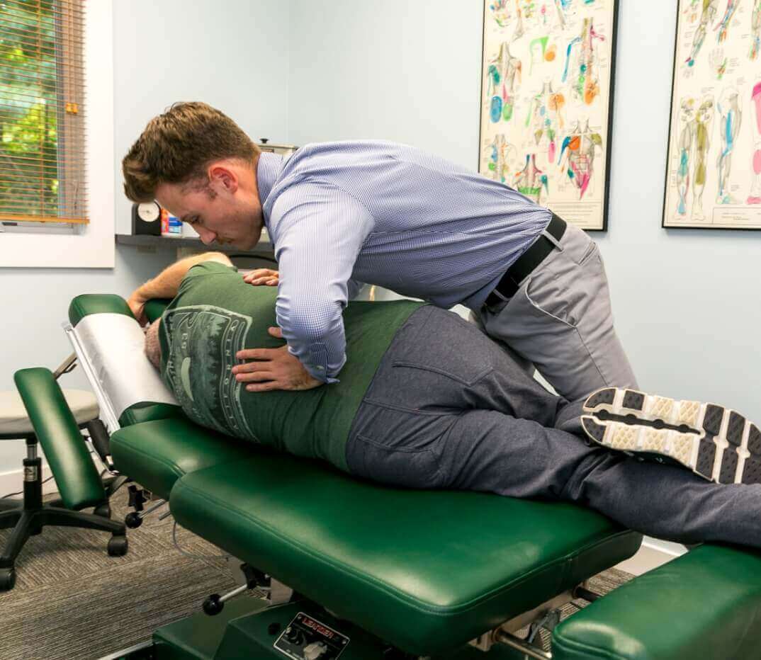 Harvard Chiropractor Dr. Skyler adjusting female patient