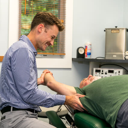 Dr. Mitchelle stretching patient's arm