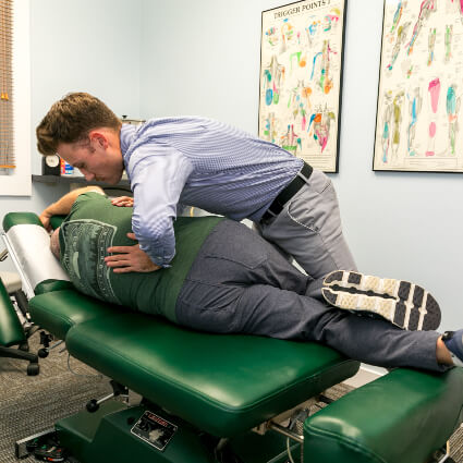 Dr. Mitchell adjusting man's back