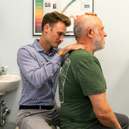 Dr. Mitchelle adjusting man's neck