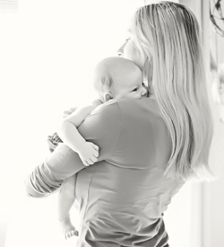 woman holding infant Protect your babies health for the long haul.