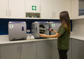 Staff member preparing instruments for sterilization