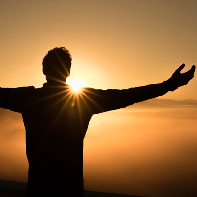 man on mountain top sunset