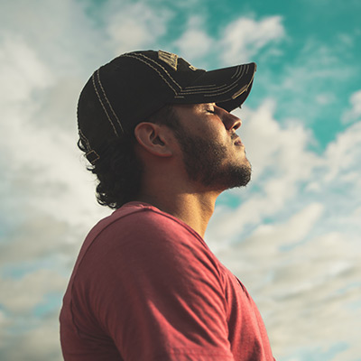 man outside breathing deeply