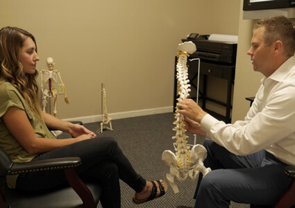 doctor consult holding spine model