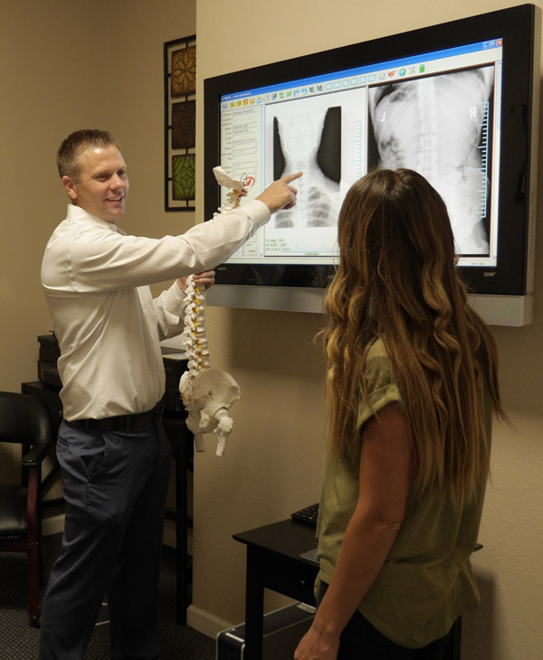 Dr. Alexander showing digital x-rays to a patient