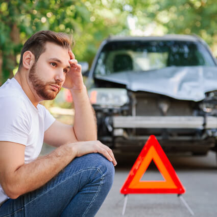 worried-man-sitting-near-car-with-orange-warning-triangle-sq (2)
