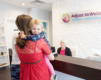 Woman and child being welcomed into Adjust To Wellness Family Chiropractic
